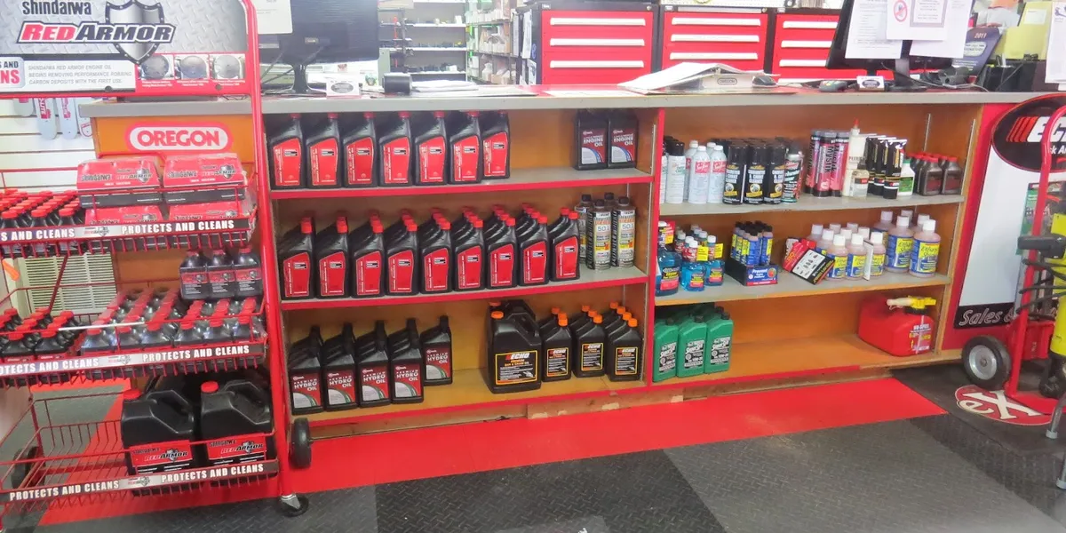 Spacious lawn equipment showroom with organized displays of zero-turn mowers and outdoor power tools, featuring an...