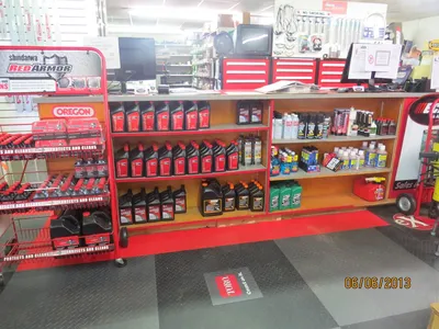 Spacious lawn equipment showroom with organized displays of zero-turn mowers and outdoor power tools, featuring an...