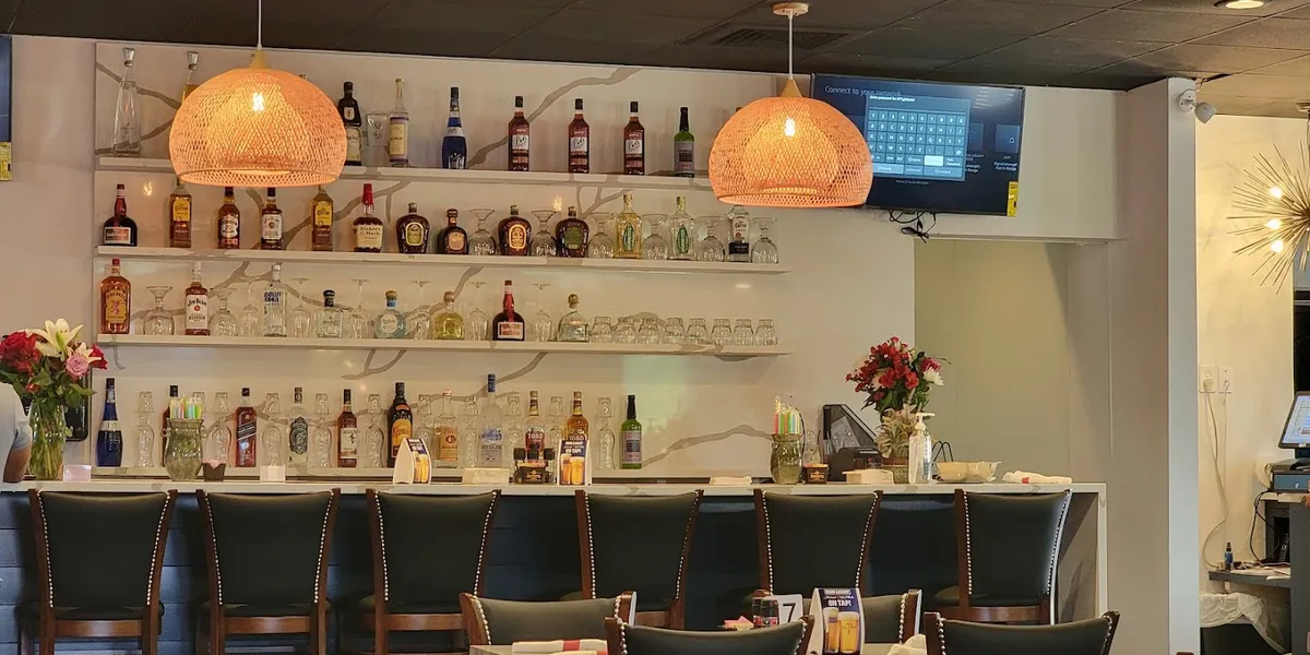 Spacious Mexican restaurant with dual personality - upscale dining area meets sports bar atmosphere, featuring outdoor...