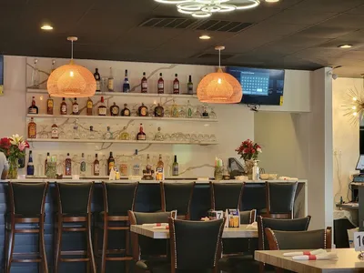 Spacious Mexican restaurant with dual personality - upscale dining area meets sports bar atmosphere, featuring outdoor...