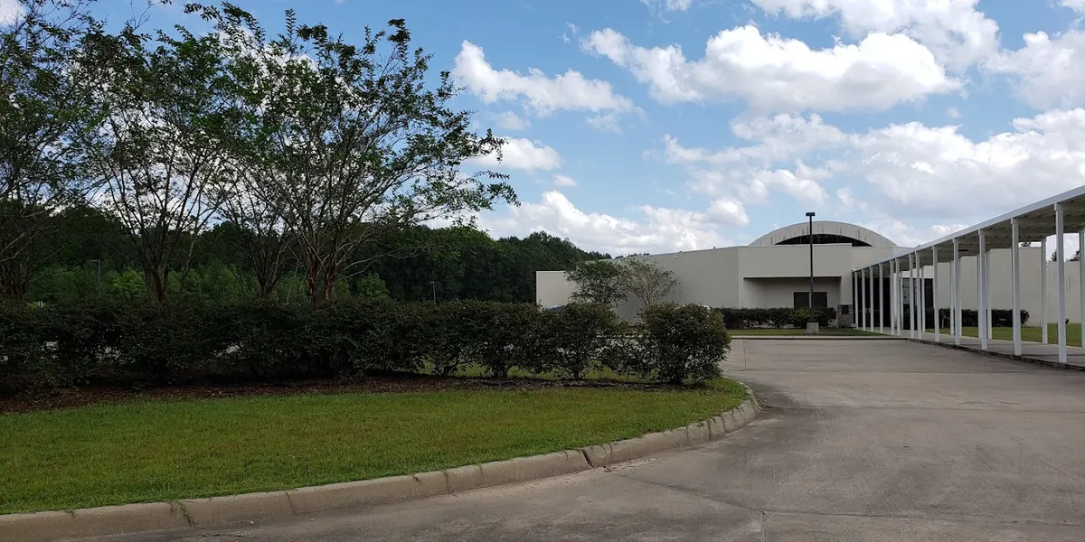 Spacious museum with stained concrete floors displaying African American art exhibits and themed cultural displays in a...
