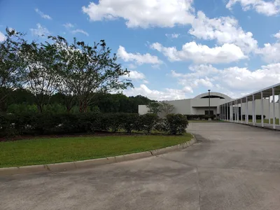 Spacious museum with stained concrete floors displaying African American art exhibits and themed cultural displays in a...