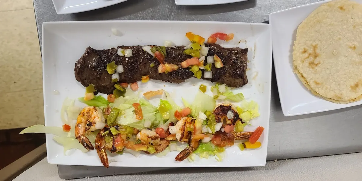 Cozy Latin American restaurant with homestyle cooking area, serving authentic Honduran dishes and café con leche in West...