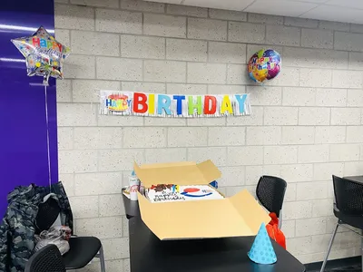 Custom-designed celebration cake with delicate gold accents and fresh berries at Allbritton's Cake House, showcasing...