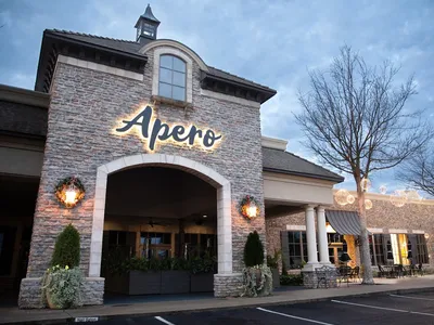 Elegantly appointed dining room with stylish decor, featuring both intimate indoor seating and a spacious outdoor patio...