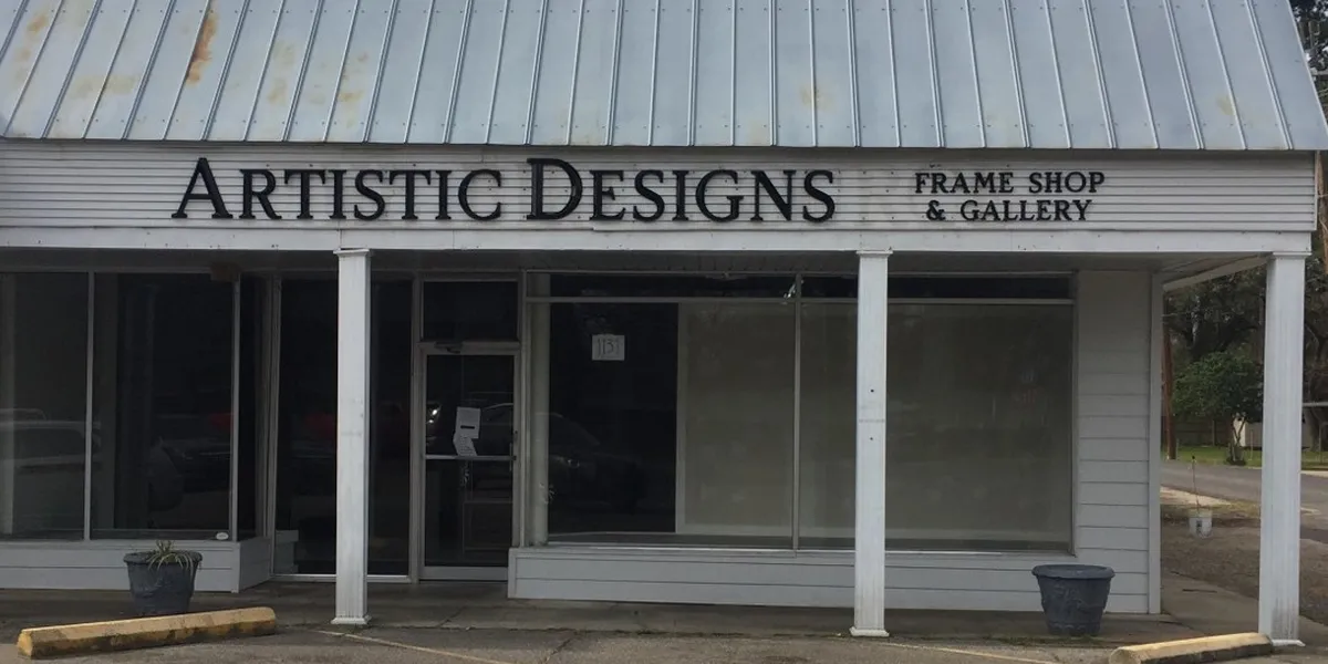 Custom picture frame shop interior with framing samples displayed along walls and skilled staff providing personalized...