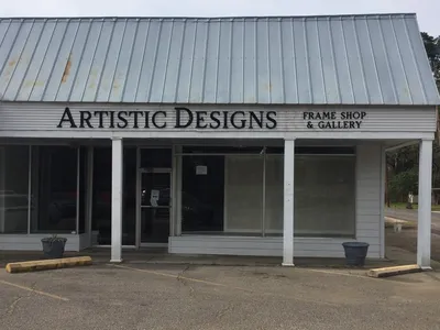 Custom picture frame shop interior with framing samples displayed along walls and skilled staff providing personalized...