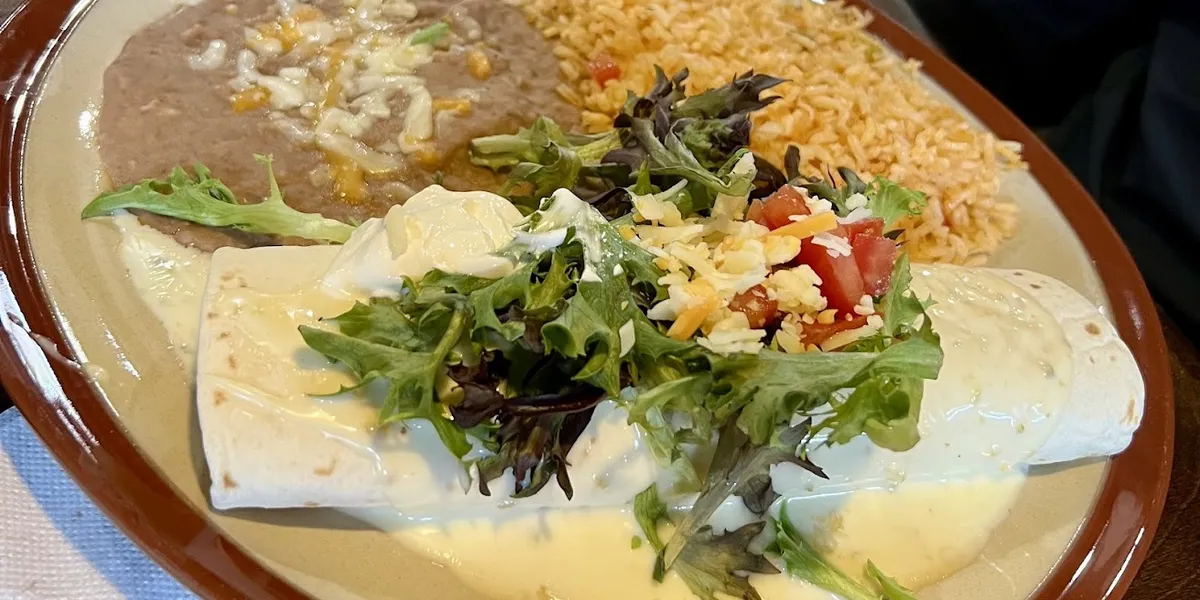 Dimly-lit Mexican restaurant with traditional decor, outdoor seating area, and bar service in a vintage setting on North...