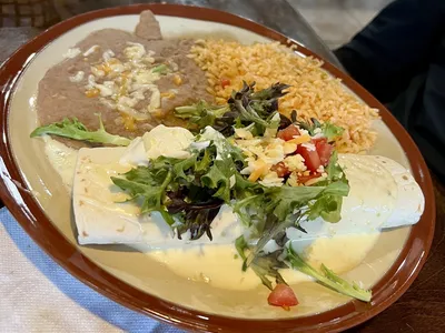 Dimly-lit Mexican restaurant with traditional decor, outdoor seating area, and bar service in a vintage setting on North...