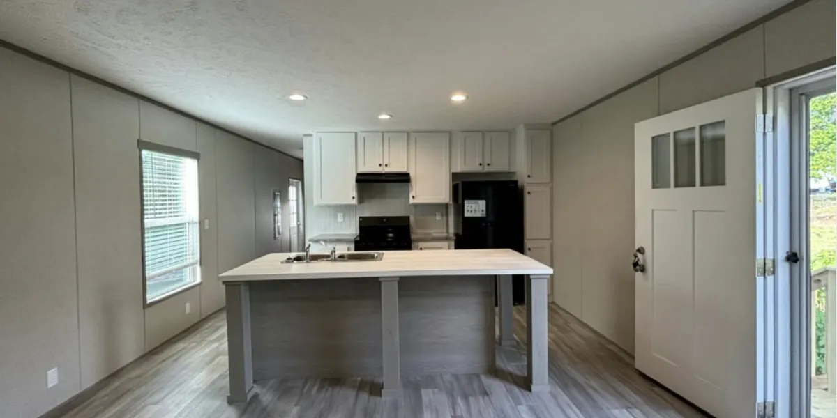 Neat rows of well-kept mobile homes with clean grounds, family-friendly common areas, and prominent speed bumps...