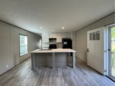 Neat rows of well-kept mobile homes with clean grounds, family-friendly common areas, and prominent speed bumps...