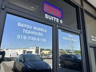 Cozy Vietnamese teahouse with traditional pho bowls and colorful bubble tea drinks served in a casual, family-friendly...