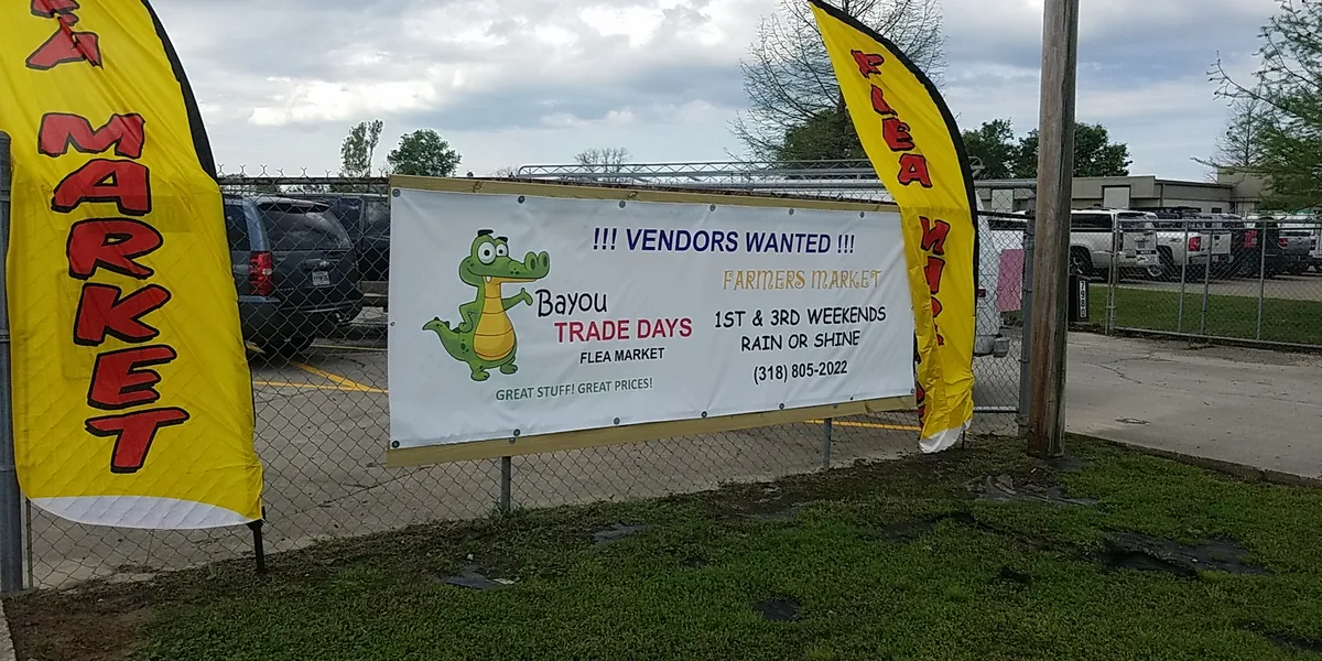 Open-air market with diverse vendor booths selling handcrafted goods and produce, families strolling between...