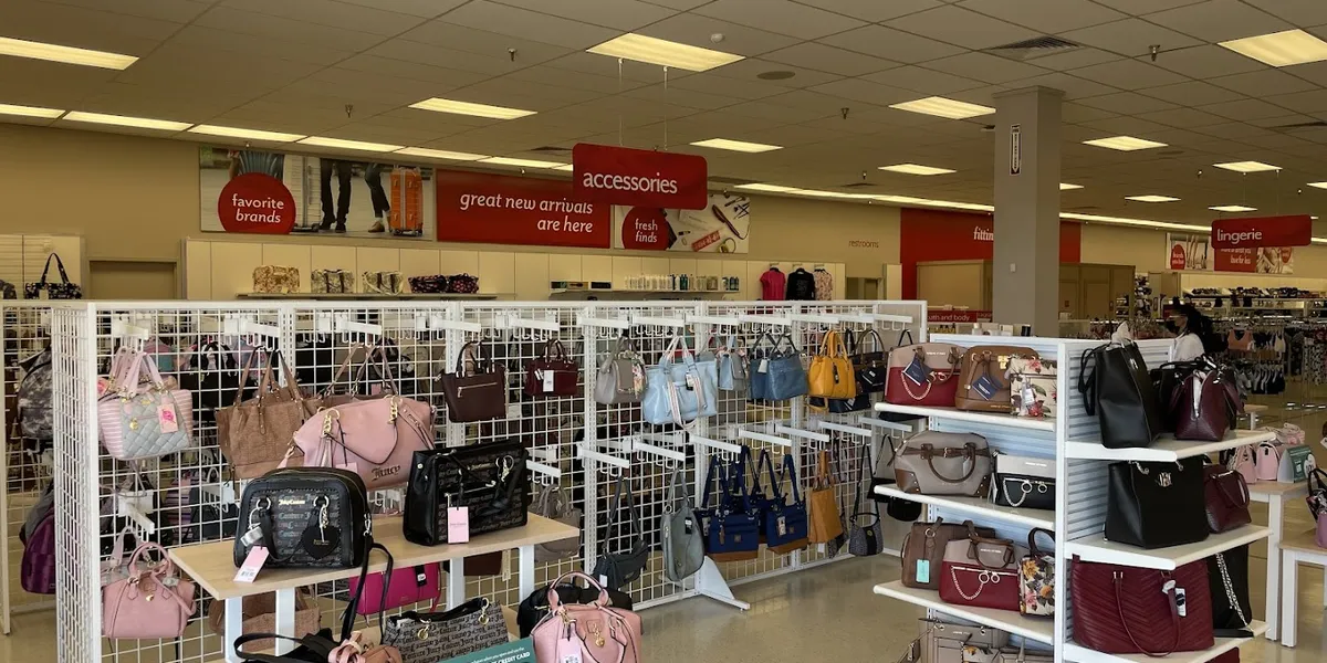 Neatly arranged clothing racks and household items in a bright, clean retail space with visible price tags highlighting...