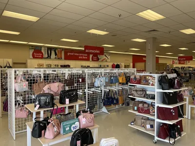 Neatly arranged clothing racks and household items in a bright, clean retail space with visible price tags highlighting...