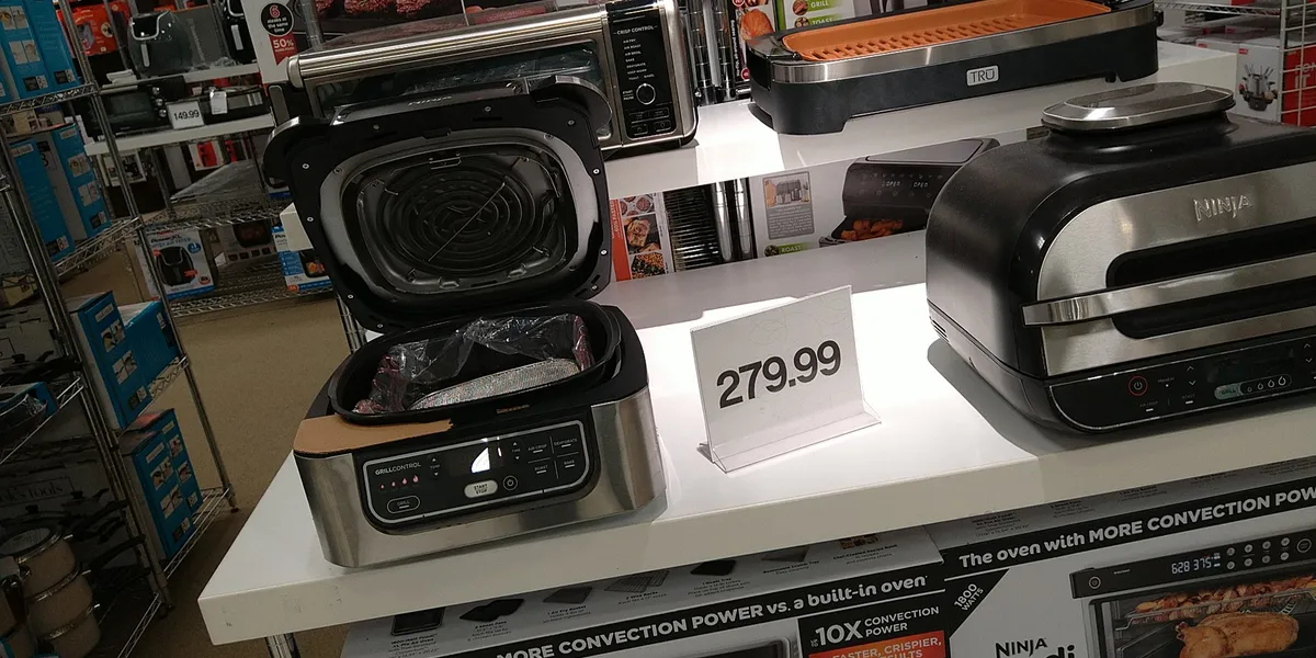 Interior of Belk department store showing clothing racks and merchandise displays in an open-format retail space with...