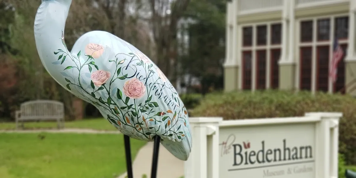 Elegant historic Biedenharn home with sprawling gardens featuring tree-sized plants and Coca-Cola memorabilia displays...