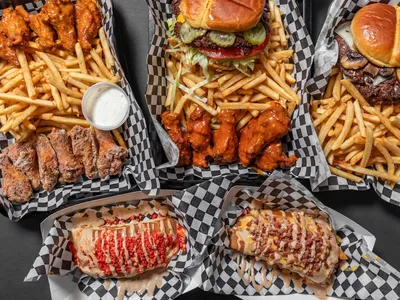 Casual bar with outdoor seating serving signature smash burgers and wings, featuring a relaxed atmosphere for dining and...