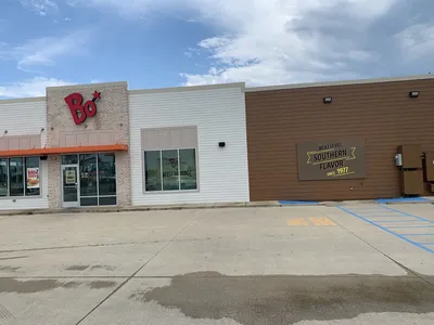 Newly redesigned Bojangles restaurant on Louisville Ave with outdoor seating area and drive-thru, showcasing...