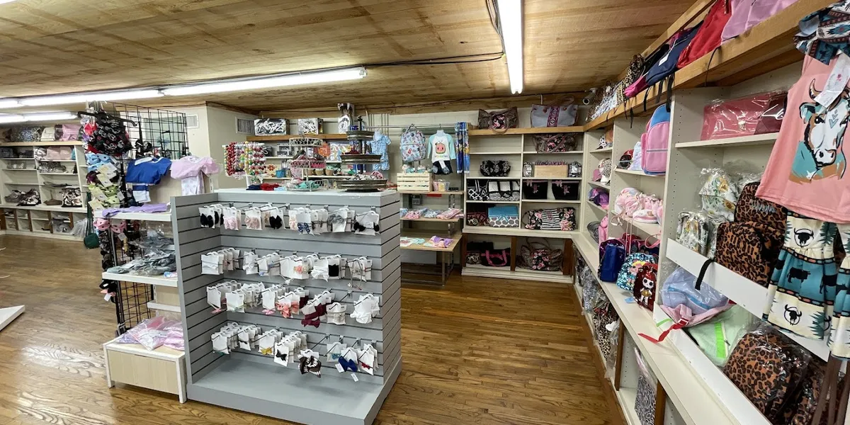 Bright, organized children's boutique with neatly arranged clothing displays and a welcoming shopping space for families...