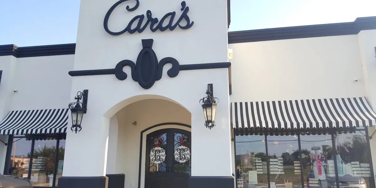 Bright, well-organized clothing boutique with racks of colorful apparel and attentive staff providing personalized...