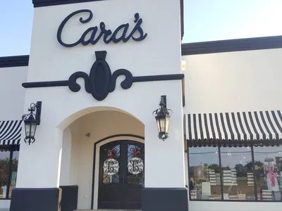 Bright, well-organized clothing boutique with racks of colorful apparel and attentive staff providing personalized...