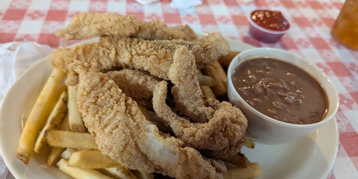 Casual seafood restaurant with simple dining area, outdoor seating option, and counter service for ordering traditional...