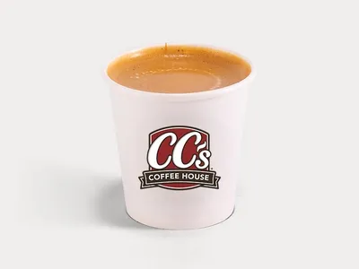 Bright coffee shop interior with counter service, outdoor seating area, and drive-thru window, bustling with morning...