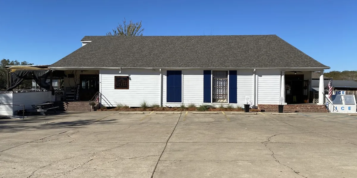 Compact neighborhood market with well-stocked shelves of groceries, prepared foods, and beverages in a bright,...