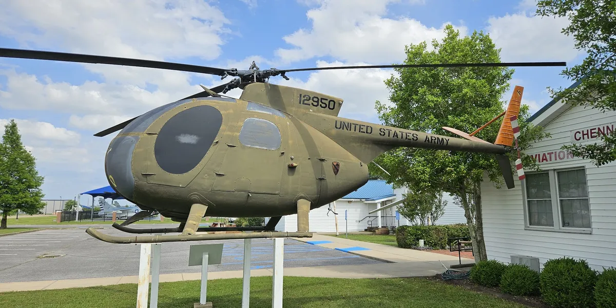 Chennault Aviation & Military Museum exterior with vintage aircraft displays on the grounds, showcasing historical planes...