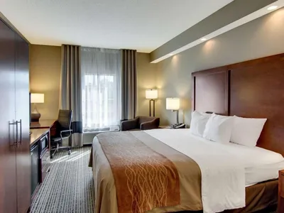 Comfort Inn West Monroe exterior showing Constitution Drive entrance, featuring the hotel's pool area and parking lot...