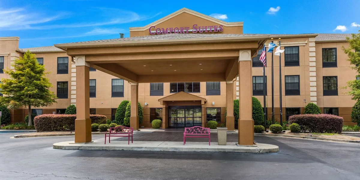 Modern hotel exterior with ample parking, featuring comfortable suites, breakfast area, and pool facilities near MLK Jr...