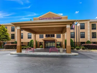 Modern hotel exterior with ample parking, featuring comfortable suites, breakfast area, and pool facilities near MLK Jr...