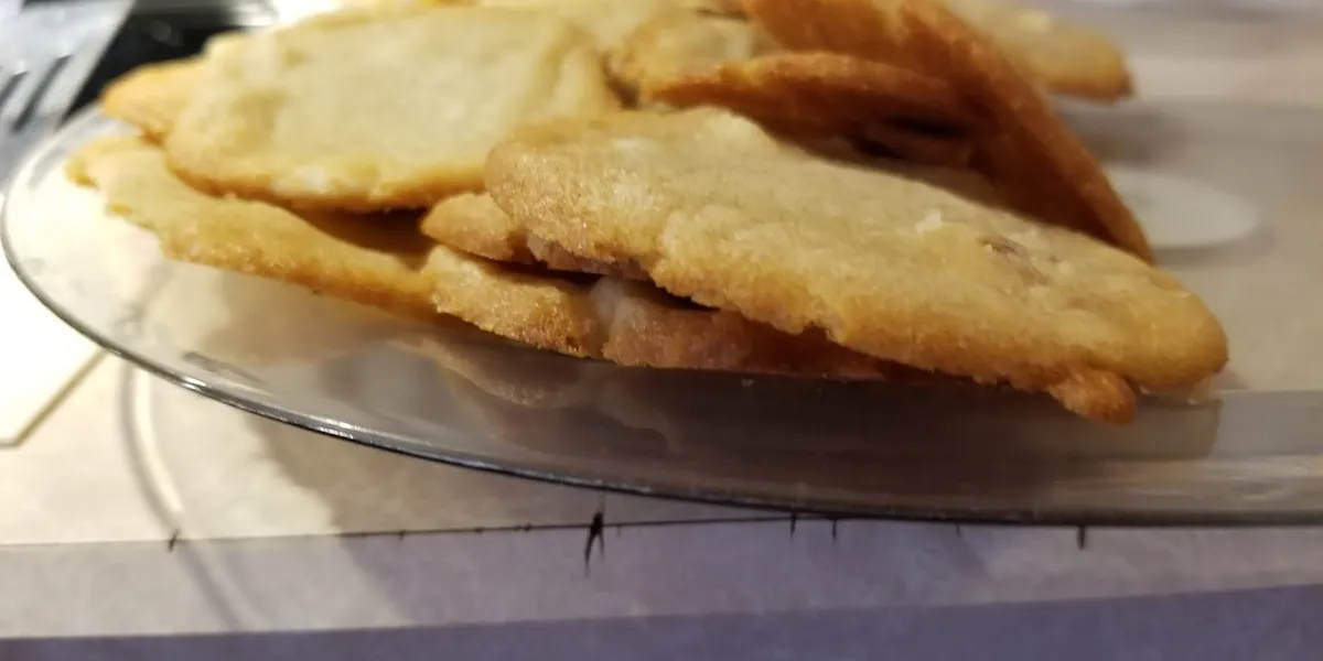 Retail cookie dough shop with fundraiser products displayed in tubs, wheelchair accessible entrance and parking area in...