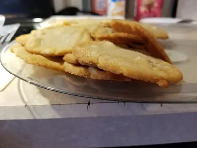 Retail cookie dough shop with fundraiser products displayed in tubs, wheelchair accessible entrance and parking area in...