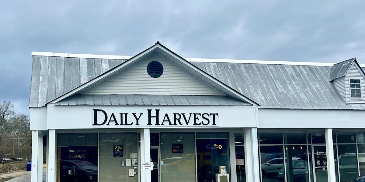 Cozy hole-in-the-wall eatery with counter service displaying freshly baked goods and a casual dining area for quick...