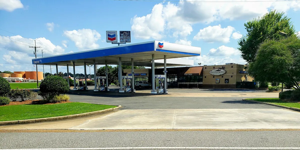 Bright cafe counter inside a credit union building with coffee equipment, display case of baked goods, and order pickup area.
