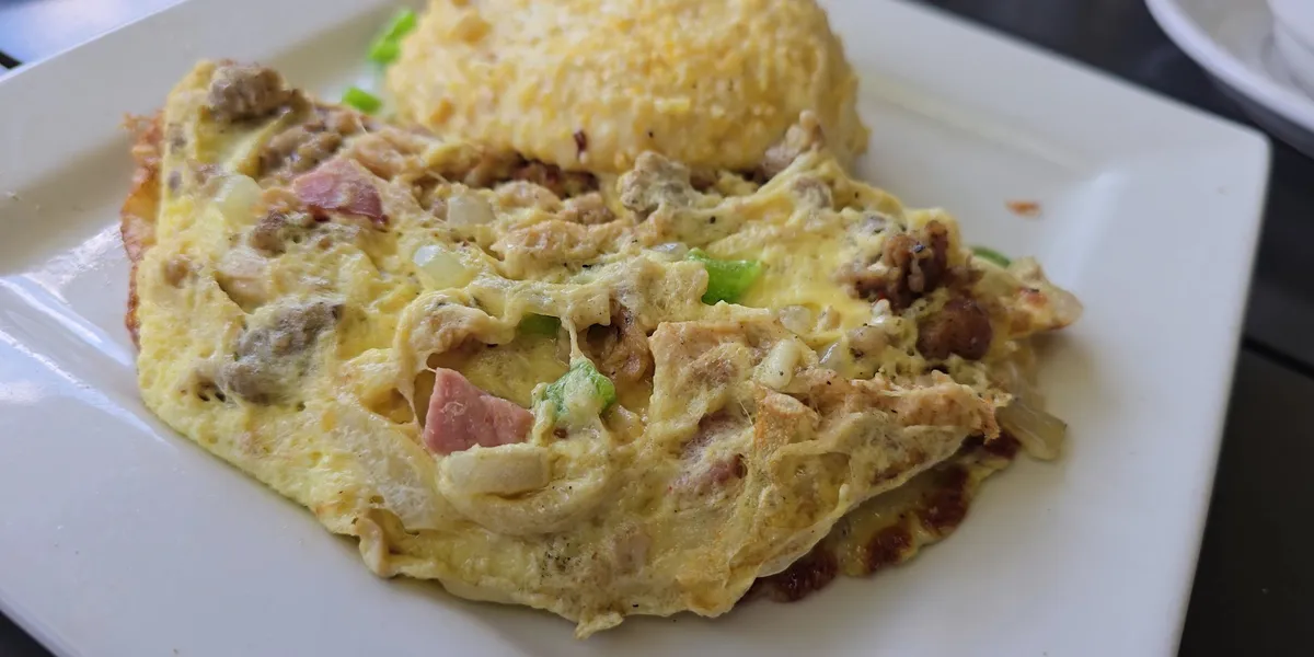 Bright, intentionally designed breakfast restaurant with bar seating and relaxed dining area serving elevated Southern...