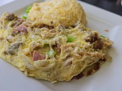 Bright, intentionally designed breakfast restaurant with bar seating and relaxed dining area serving elevated Southern...