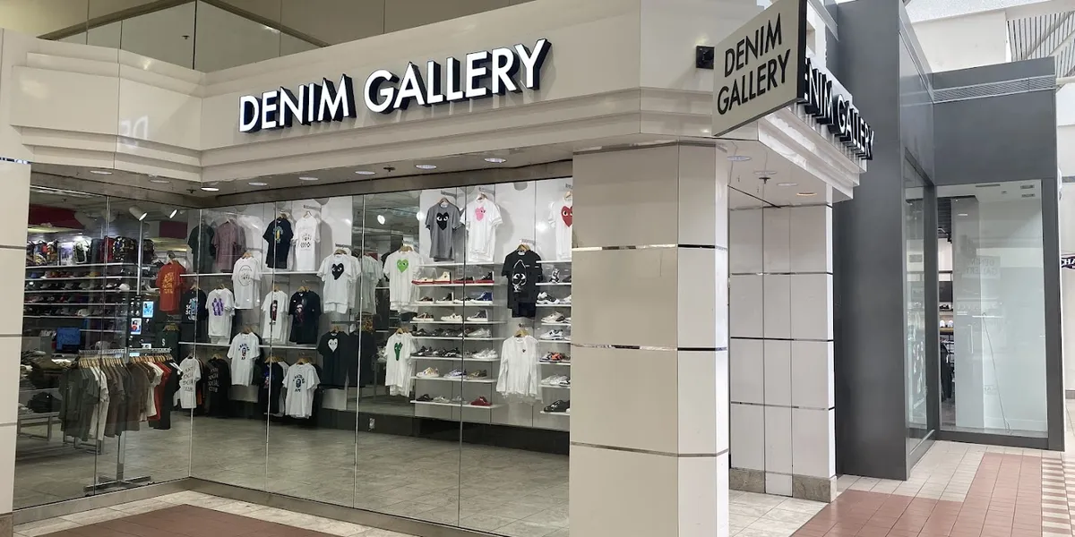 Modern clothing boutique with neatly arranged trendy apparel displays, bright lighting, and a youthful atmosphere in...