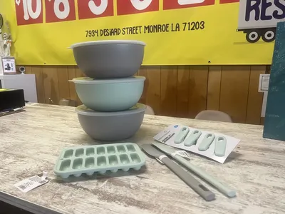 Compact but well-organized discount store with neat bins of varied merchandise and shoppers searching for bargains in a...