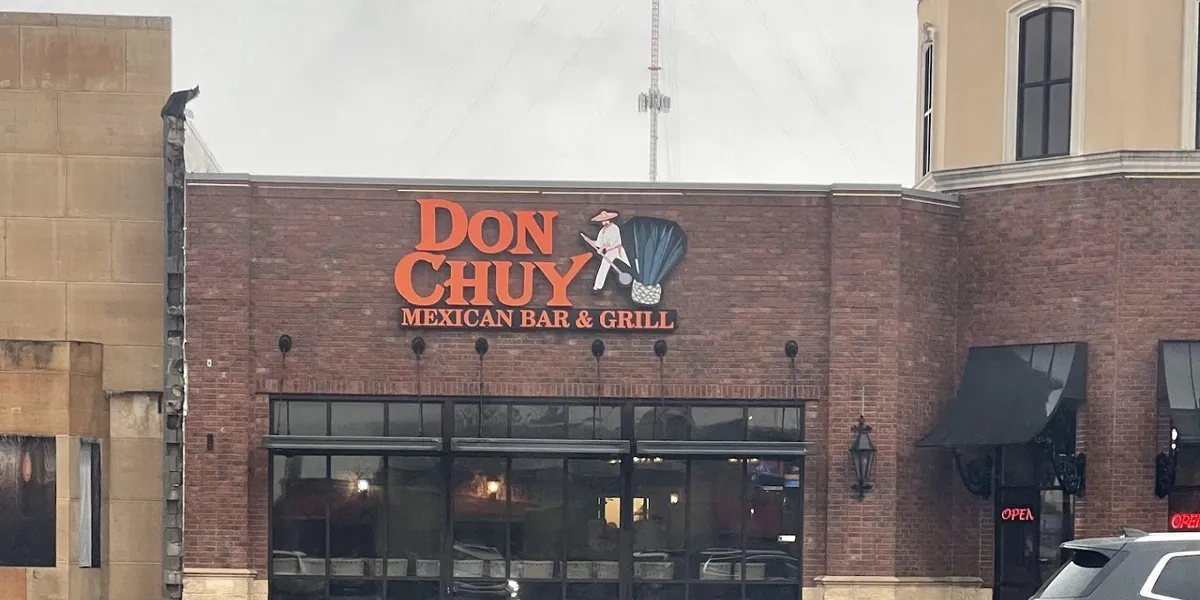 Colorful Mexican restaurant interior with bar area serving specialty margaritas and daiquiris, featuring both indoor and...