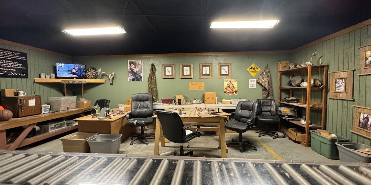 Merchandise-filled warehouse store with Duck Dynasty branded products, featuring rustic decor and potential areas for fan...