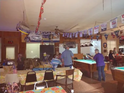 Cozy interior of Ed's neighborhood bar in West Monroe, with intimate seating, outdoor patio option, and karaoke setup for...