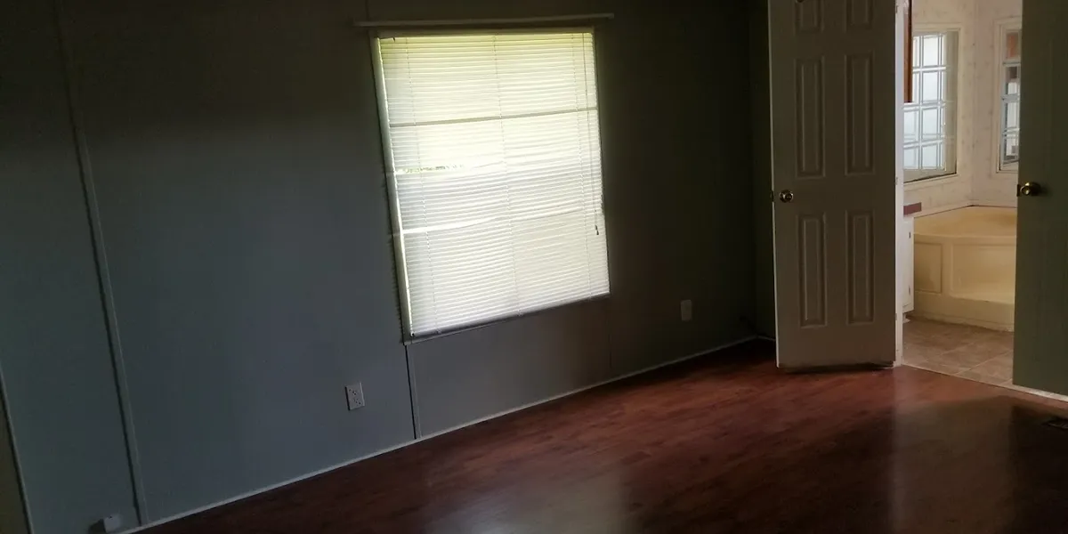 Modest mobile home community with simple layouts and basic amenities, featuring residential units arranged along quiet roads.