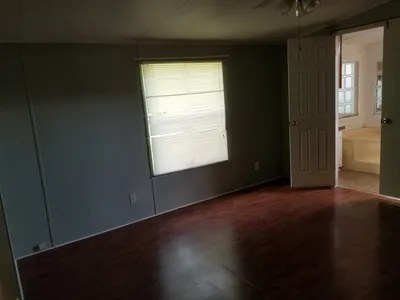 Modest mobile home community with simple layouts and basic amenities, featuring residential units arranged along quiet roads.