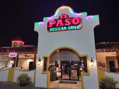 Bright Mexican restaurant with outdoor seating area, serving colorful plates of fajitas and enchiladas alongside chips...