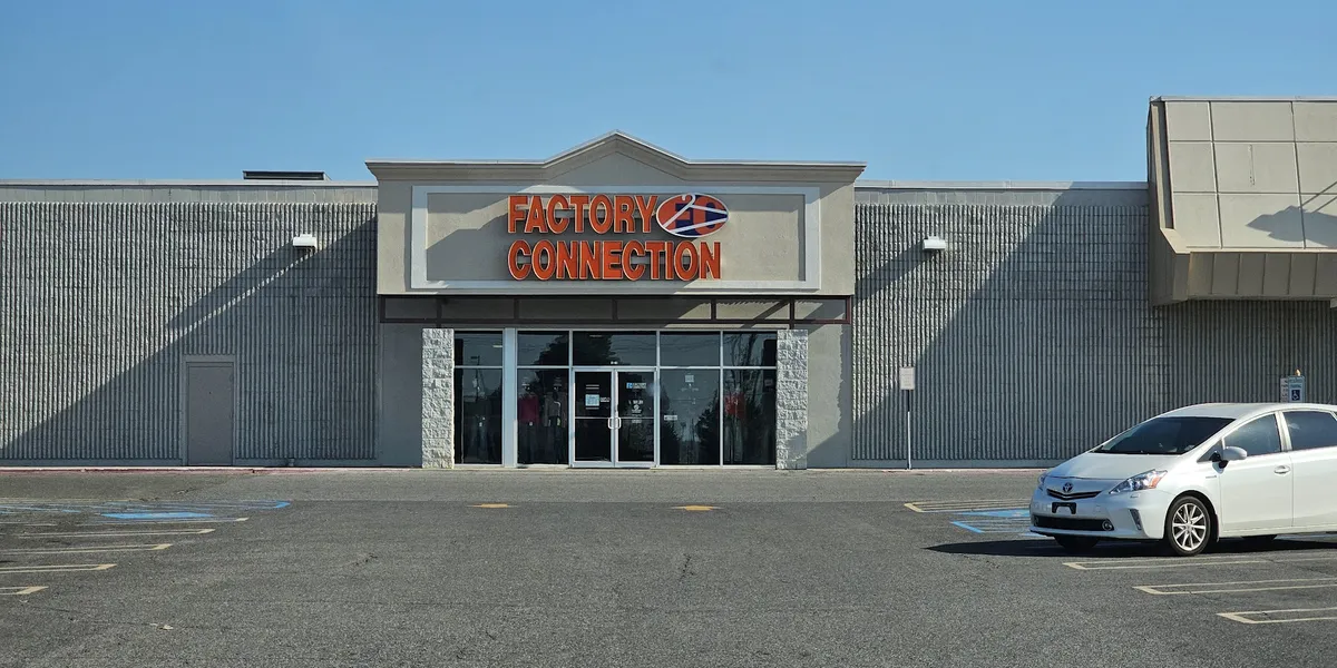 Budget clothing racks at Factory Connection with casual and trendy apparel displayed throughout the bright, no-frills...