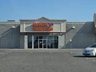 Budget clothing racks at Factory Connection with casual and trendy apparel displayed throughout the bright, no-frills...