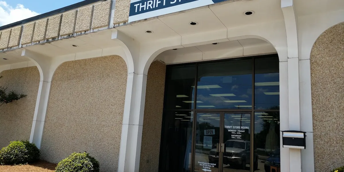 Neatly organized thrift store with diverse merchandise sections, well-displayed items, and clear signage for weekly...